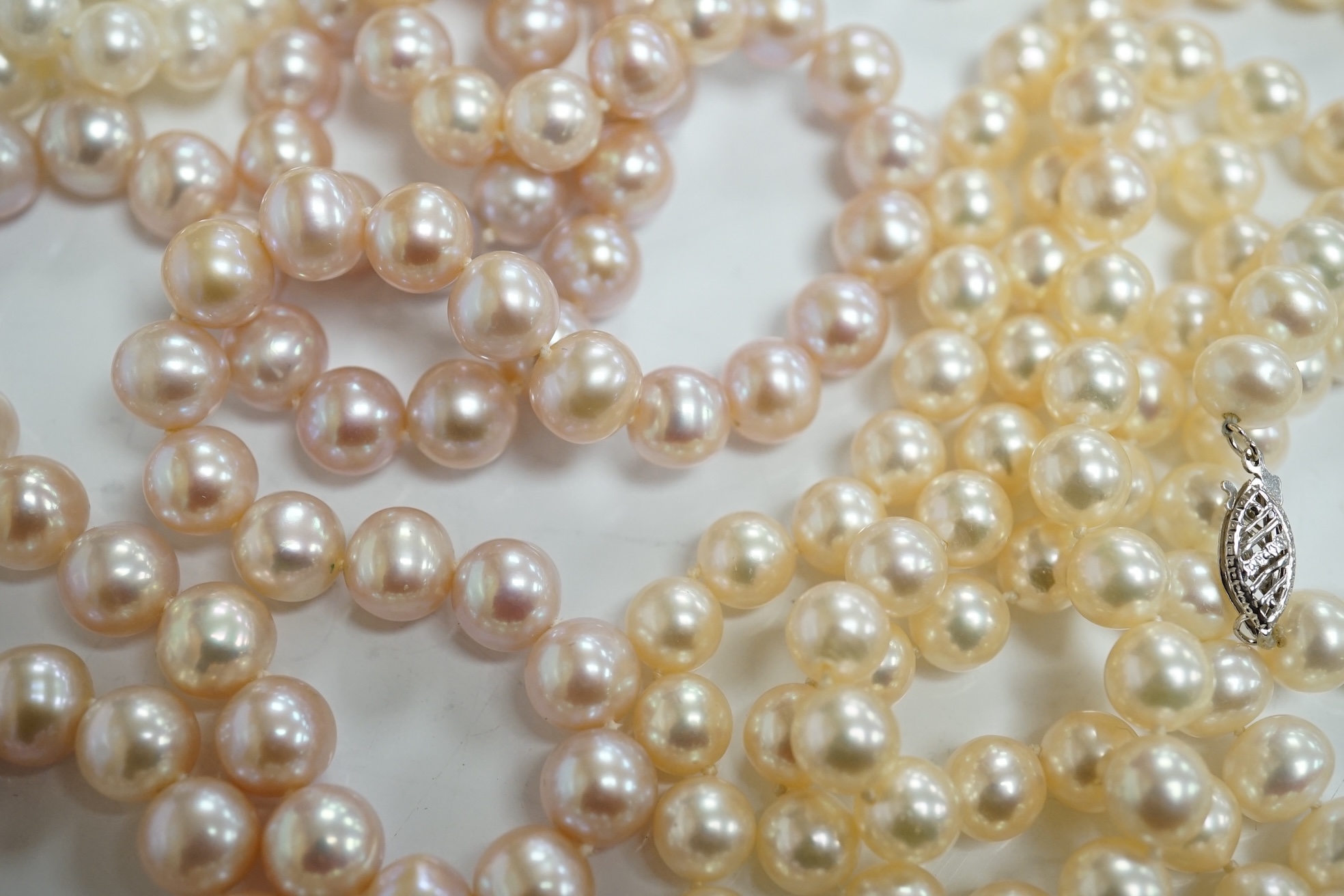 Six assorted modern single strand cultured pearl necklaces, one with 14k clasp, longest 86cm, a pair of similar bracelets, 18cm and a freshwater pearl multi strand necklace. Condition - fair to good